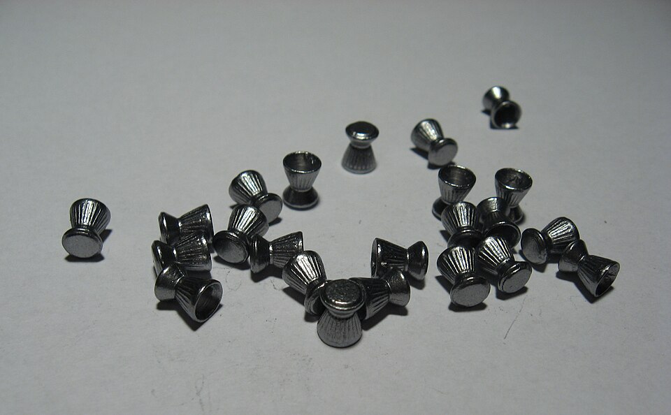 A handful of 4.5 mm diabolo air gun pellets on a table